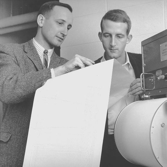 Bob (left) and a colleague examining a seismogram in his early days in the Department of Geophysics and Astronomy